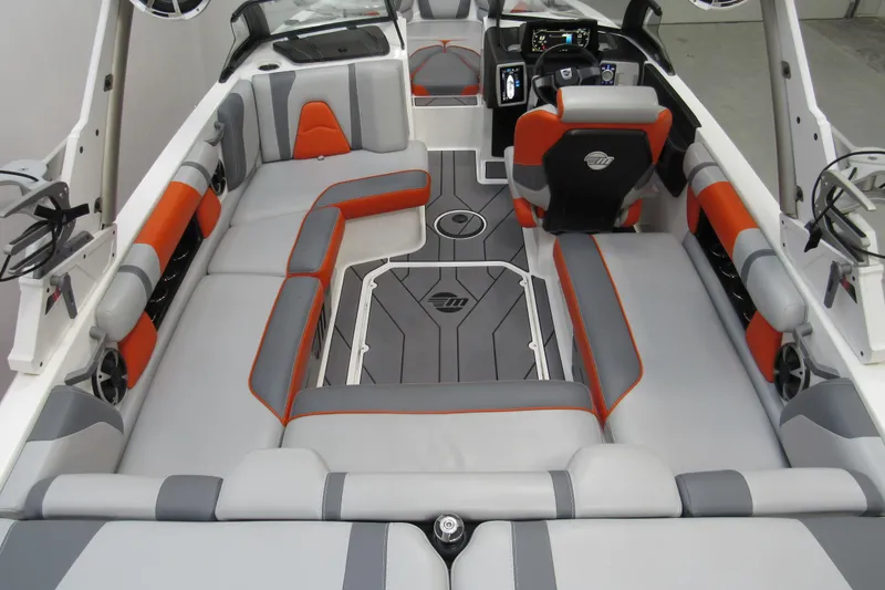 Slide: The Image of 2021 Malibu Wakesetter 21 VLX interior with gray and orange seating, modern dashboard. - 3