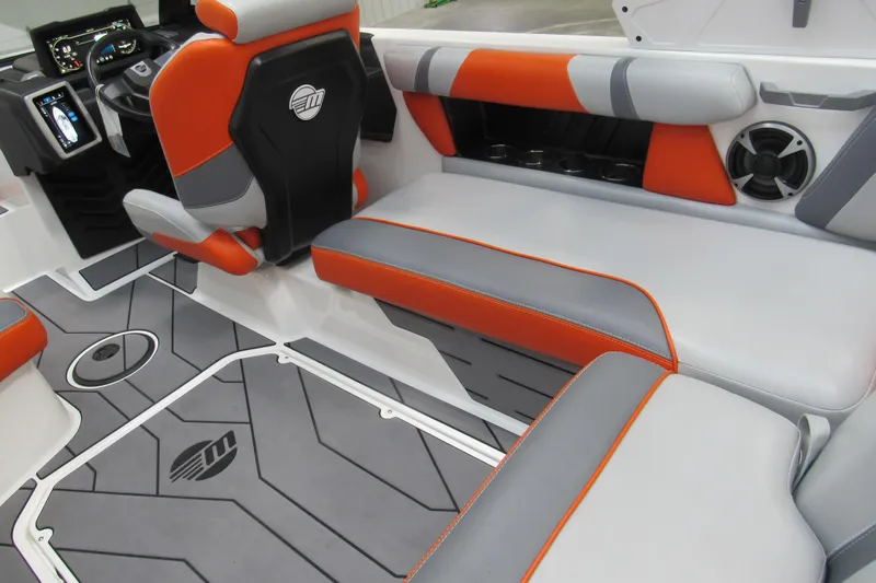 Slide: The Image of 2021 Malibu Wakesetter 21 VLX interior with orange and gray seating, modern dashboard, and speaker system. - 5