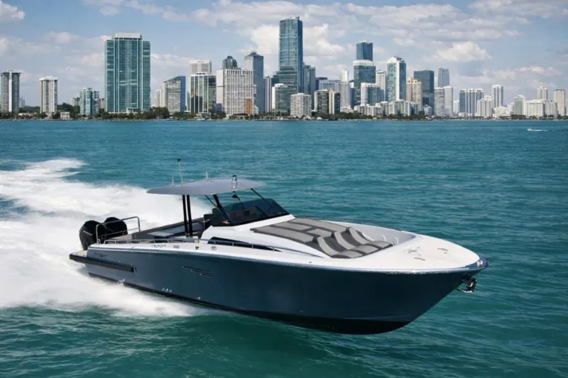 The Image of 2023 Canados 43 yacht cruising near a city skyline on a sunny day. - 0