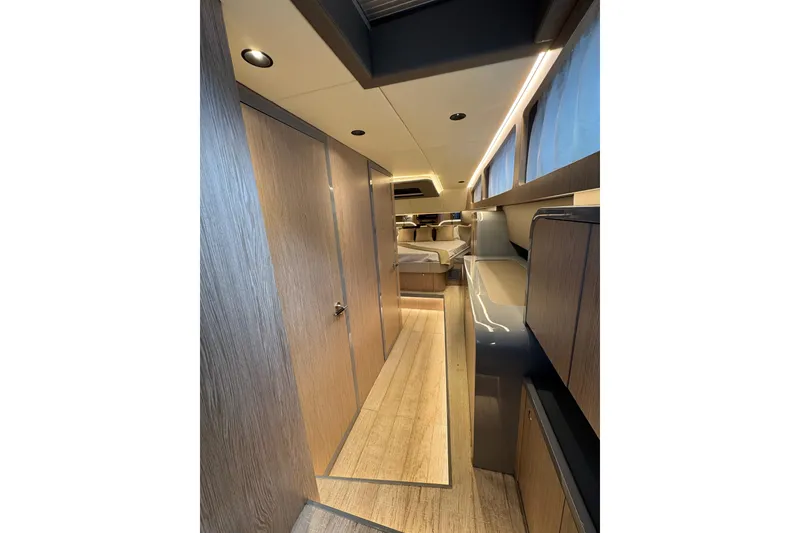 Slide: The Image of Luxurious interior of 2023 Canados 43 yacht with modern wood finishes and ambient lighting. - 11