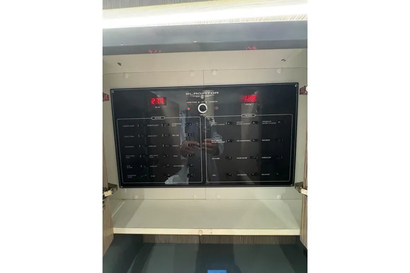 Slide: The Image of Control panel of a 2023 Canados 43 yacht, featuring various switches and digital displays. - 12