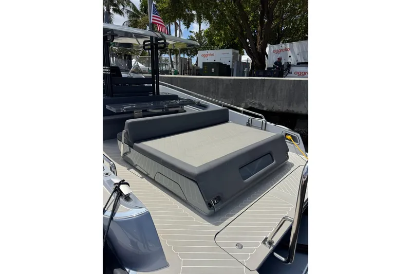 Slide: The Image of 2023 Canados 431 yacht deck with seating area, docked near palm trees and American flag. - 14