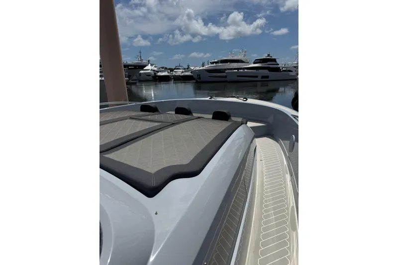 Slide: The Image of 2023 Canados 431 yacht with sleek deck design, docked at a marina under a cloudy sky. - 15