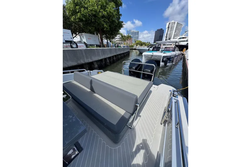 Slide: The Image of 2023 Canados 431 yacht docked, featuring sleek seating and modern design. - 28