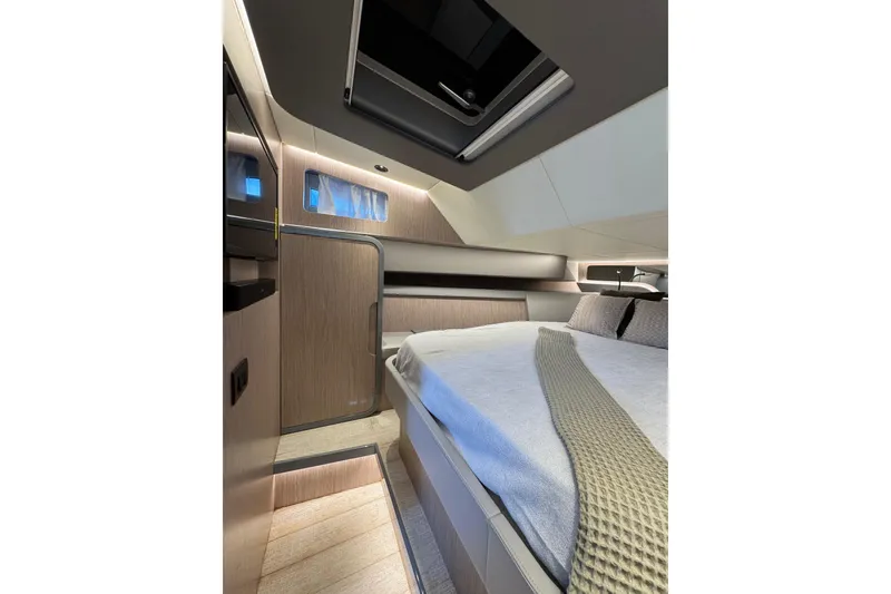 Slide: The Image of Luxurious interior cabin of 2023 Canados 43 yacht, featuring modern design and cozy bedding. - 3