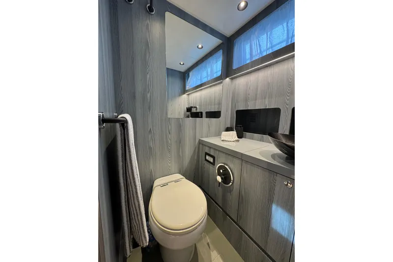 Slide: The Image of Modern bathroom interior on 2023 Canados 43 yacht, featuring sleek wood paneling and elegant fixtures. - 5