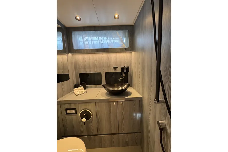 Slide: The Image of Modern bathroom interior of 2023 Canados 43 yacht with sleek fixtures and wood paneling. - 7