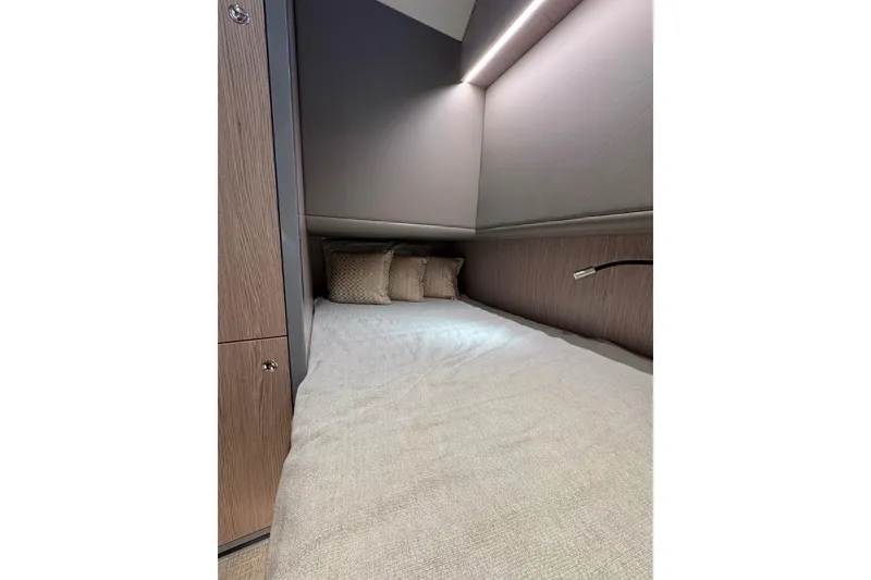 Slide: The Image of Luxurious cabin interior of 2023 Canados 43 yacht with cozy bedding and ambient lighting. - 9