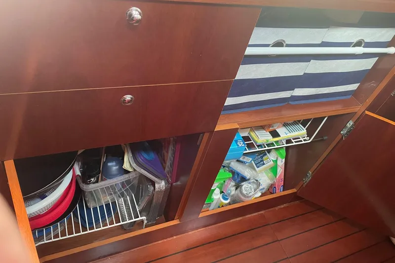 Slide: The Image of Storage cabinets inside a 2005 Beneteau Oceanis 42CC yacht, featuring organized supplies. - 11