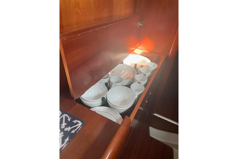 Slide: The Image of Cabinet with dishes and cups inside a 2005 Beneteau Oceanis 42CC yacht. - 12