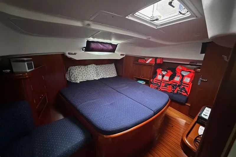 Slide: The Image of Cozy cabin interior of 2005 Beneteau Oceanis 42CC with bed and life jackets. - 15