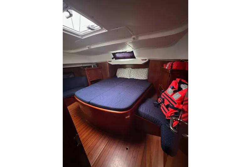 Slide: The Image of Cozy cabin interior of 2005 Beneteau Oceanis 42CC sailboat with blue bedding. - 16