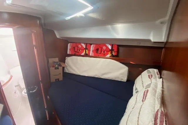 Slide: The Image of Cozy cabin interior of 2005 Beneteau Oceanis 42CC sailboat with bed and storage. - 19