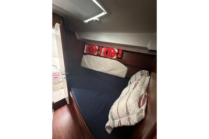 Slide: The Image of Cozy cabin interior of 2005 Beneteau Oceanis 42CC sailboat with bed and storage. - 20