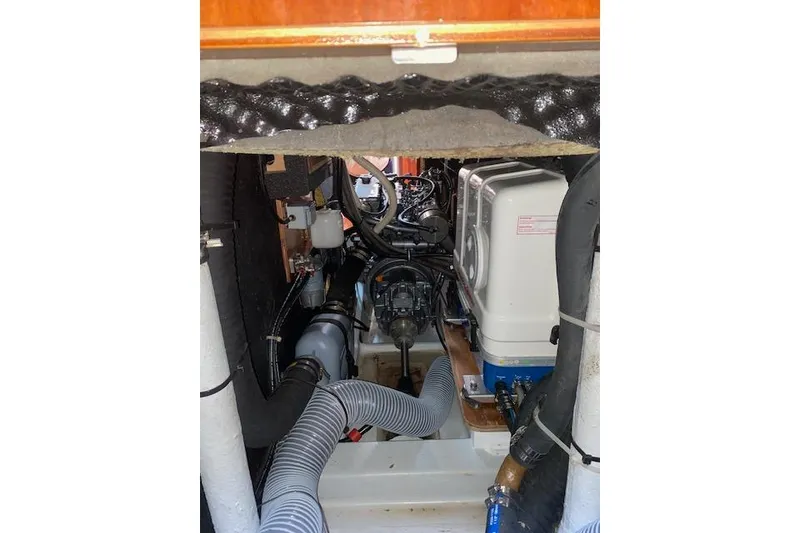 Slide: The Image of Engine compartment of a 2005 Beneteau Oceanis 42CC sailboat, showcasing mechanical components. - 25