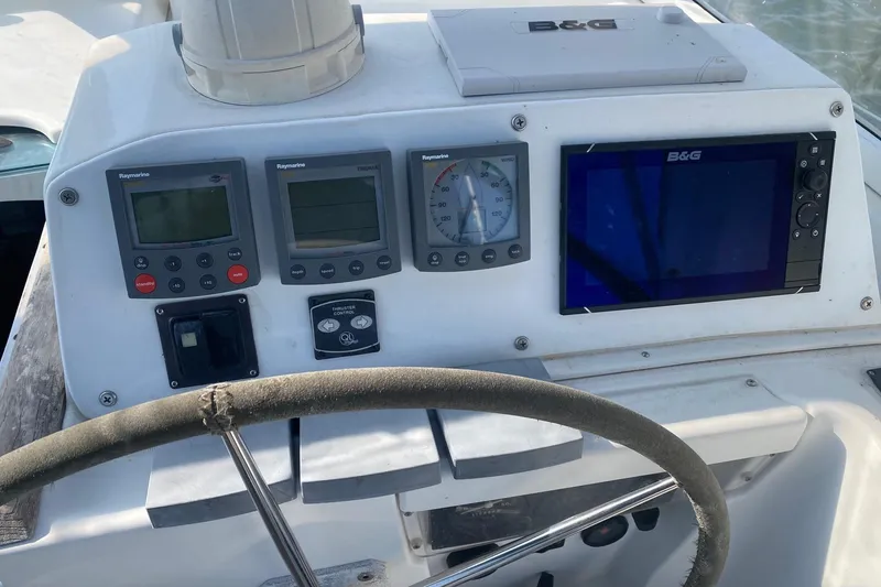Slide: The Image of Cockpit of 2005 Beneteau Oceanis 42CC with navigation instruments and steering wheel. - 29