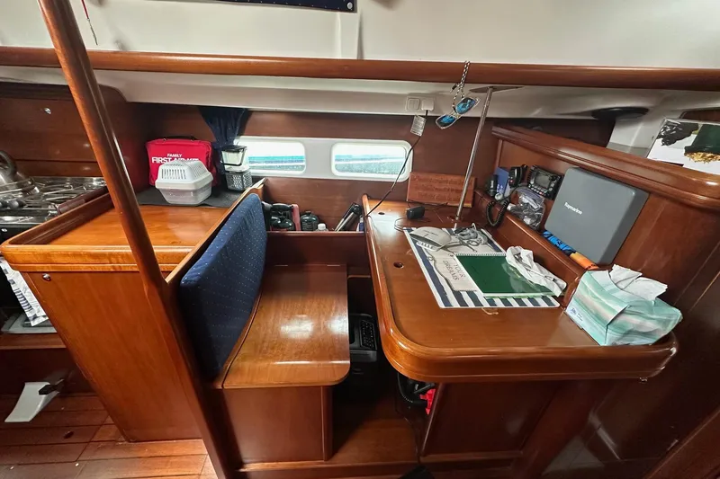 Slide: The Image of Interior of 2005 Beneteau Oceanis 42CC sailboat with navigation station and wooden finish. - 3
