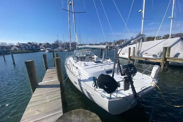 Slide: The Image of 2005 Beneteau Oceanis 42CC sailboat docked at a marina under clear blue skies. - 33