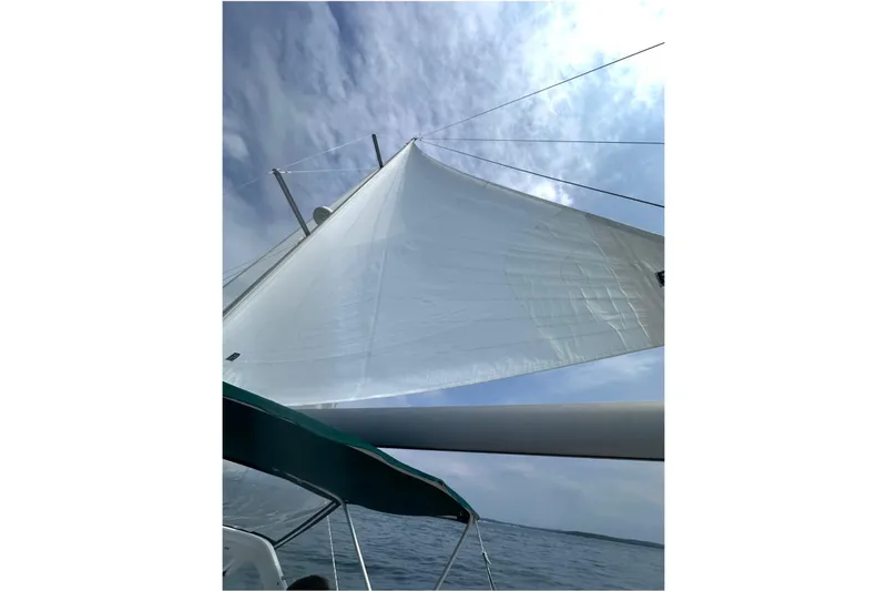 Slide: The Image of Sailing on a 2005 Beneteau Oceanis 42CC with white sails against a cloudy sky. - 34