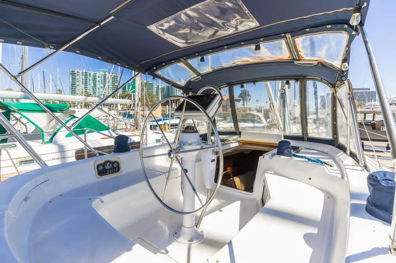 Slide: The Image of Cockpit of 2000 Hunter Passage 420 sailboat with steering wheel and marina view. - 12