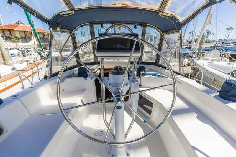 Slide: The Image of Cockpit of 2000 Hunter Passage 420 sailboat with steering wheel and navigation equipment. - 14