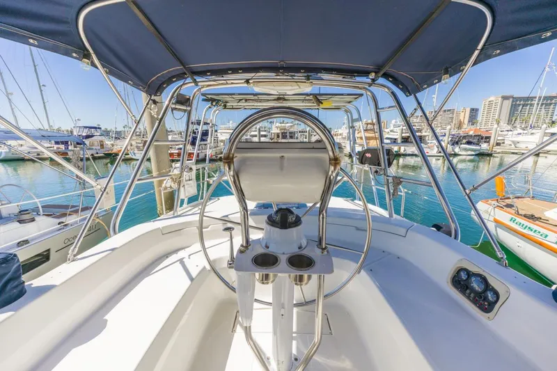 Slide: The Image of Cockpit view of 2000 Hunter Passage 420 sailboat in marina, featuring steering wheel and canopy. - 17