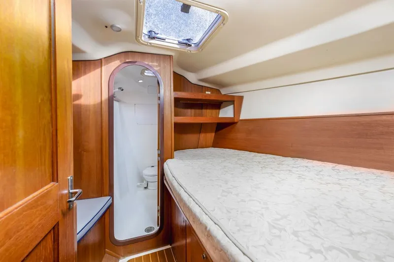 Slide: The Image of Interior cabin of 2000 Hunter Passage 420 yacht with bed and compact bathroom. - 21