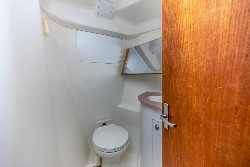 Slide: The Image of Compact bathroom in 2000 Hunter Passage 420 yacht with toilet and mirror. - 22