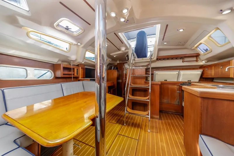 Slide: The Image of Interior of 2000 Hunter Passage 420 yacht with wooden furnishings and seating area. - 24