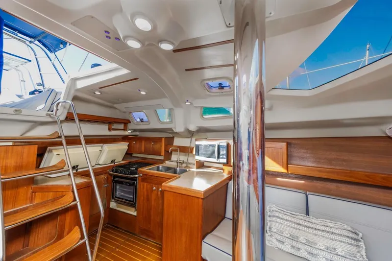 Slide: The Image of Interior of 2000 Hunter Passage 420 sailboat with wood finish and modern amenities. - 25