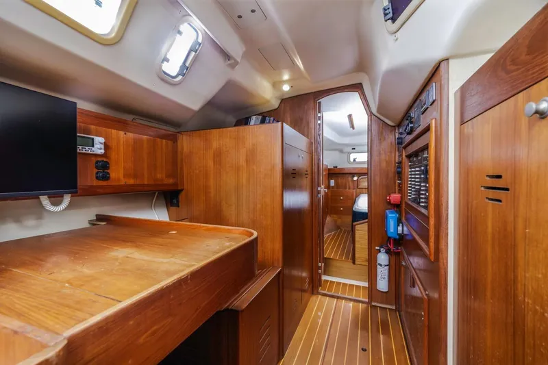 Slide: The Image of Interior of 2000 Hunter Passage 420 sailboat with wooden cabinetry and modern amenities. - 28