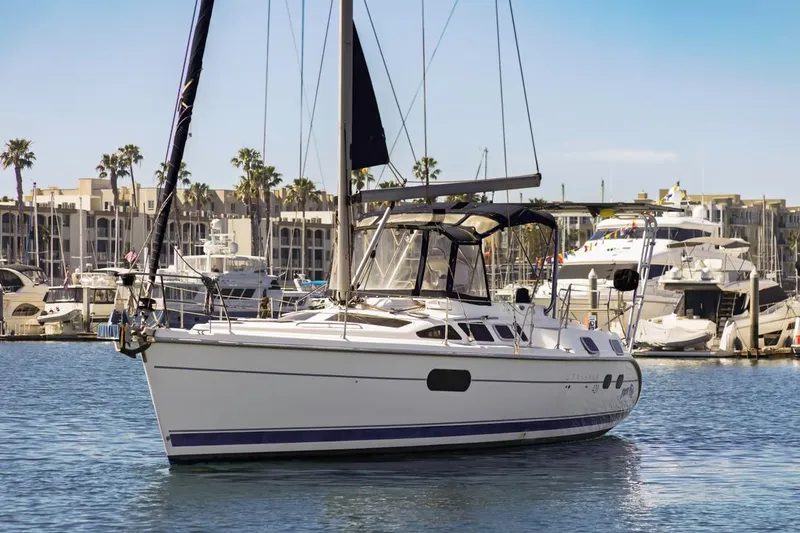 Slide: The Image of 2000 Hunter Passage 420 sailboat docked in marina with palm trees and yachts. - 3