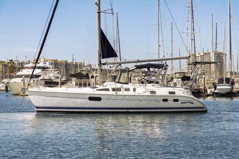 Slide: The Image of 2000 Hunter Passage 420 sailboat docked in marina, clear sky, calm water. - 4