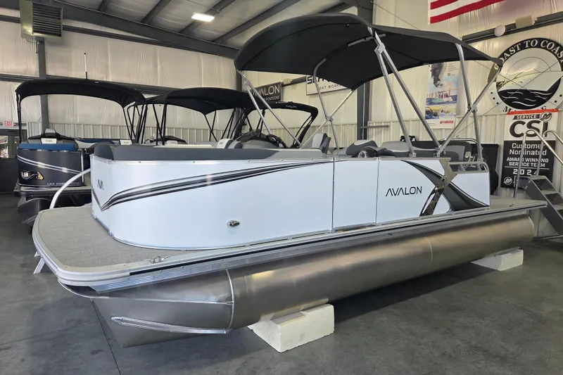 The Image of 2026 Avalon LSZ 2185 Cruise Rear Bench pontoon boat displayed indoors. - 0