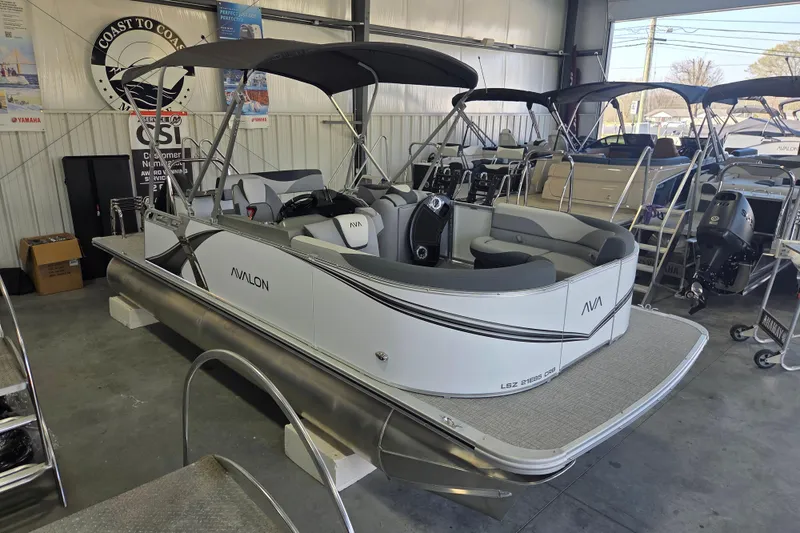 Slide: The Image of 2026 Avalon LSZ 2185 Cruise Rear Bench pontoon boat in showroom. - 2