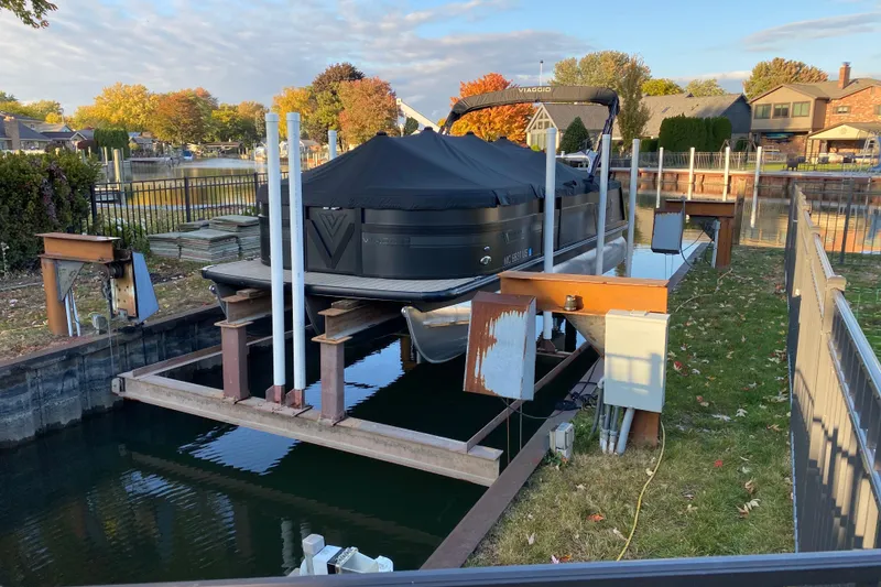 Slide: The Image of Covered 2023 Viaggio Diamante 23 U boat docked in a residential canal setting. - 8