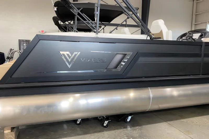Slide: The Image of 2023 Viaggio Diamante 23 U pontoon boat in showroom, sleek black design. - 9