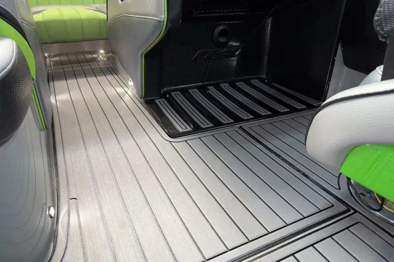 Slide: The Image of Interior of 2015 MB B-52 23 Widebody boat with sleek flooring and green accents. - 10