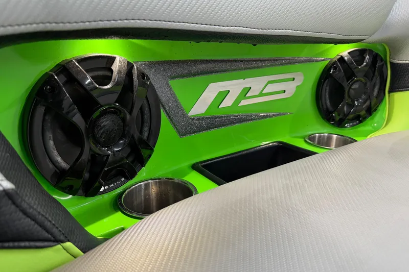 Slide: The Image of Interior of 2015 MB B-52 23 Widebody with green speaker panel and logo. - 12