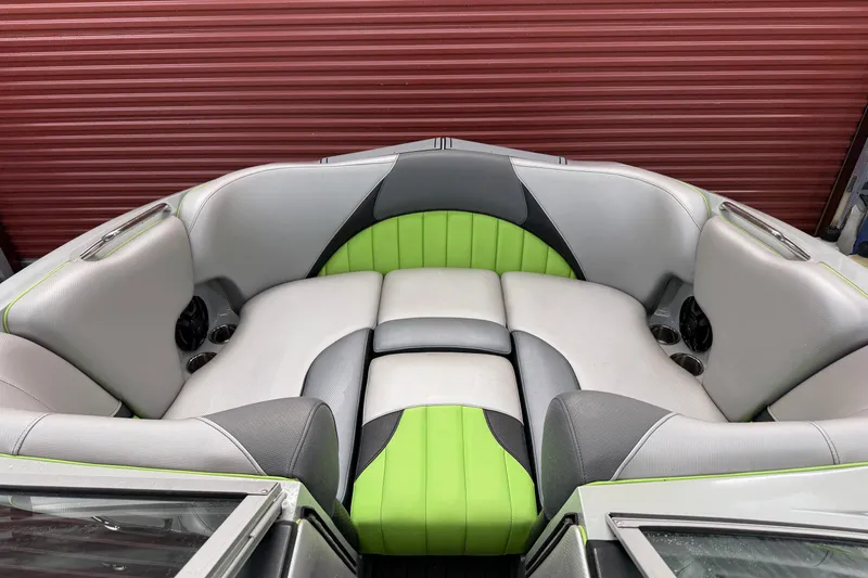 Slide: The Image of 2015 MB B-52 23 Widebody boat interior with green and gray seating. - 14