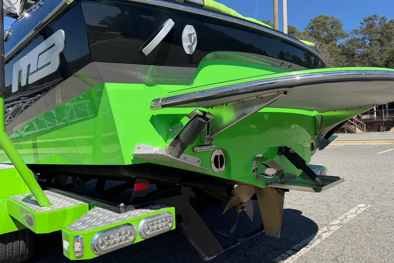 Slide: The Image of 2015 MB B-52 23 Widebody boat, vibrant green, rear view with propeller and platform. - 3