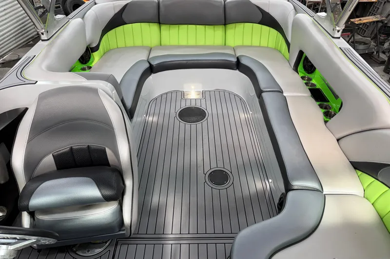 Slide: The Image of 2015 MB B-52 23 Widebody boat interior with gray and green seating. - 8