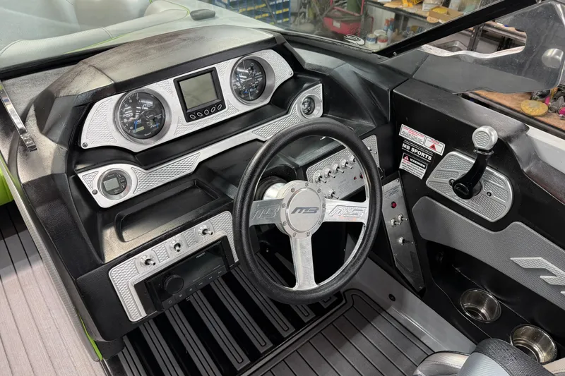 Slide: The Image of Dashboard of a 2015 MB B-52 23 Widebody boat with steering wheel and gauges. - 9
