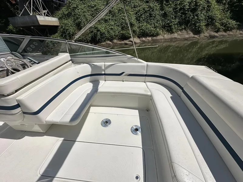 Slide: The Image of 2000 Formula 330 SS boat interior with white seating and blue accents. - 12