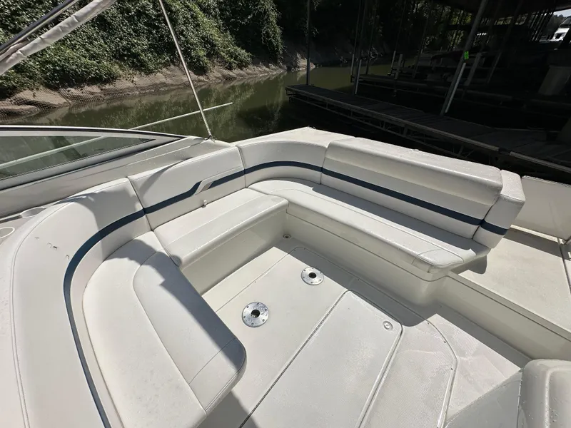 Slide: The Image of 2000 Formula 330 SS boat with spacious white seating area by the water. - 13