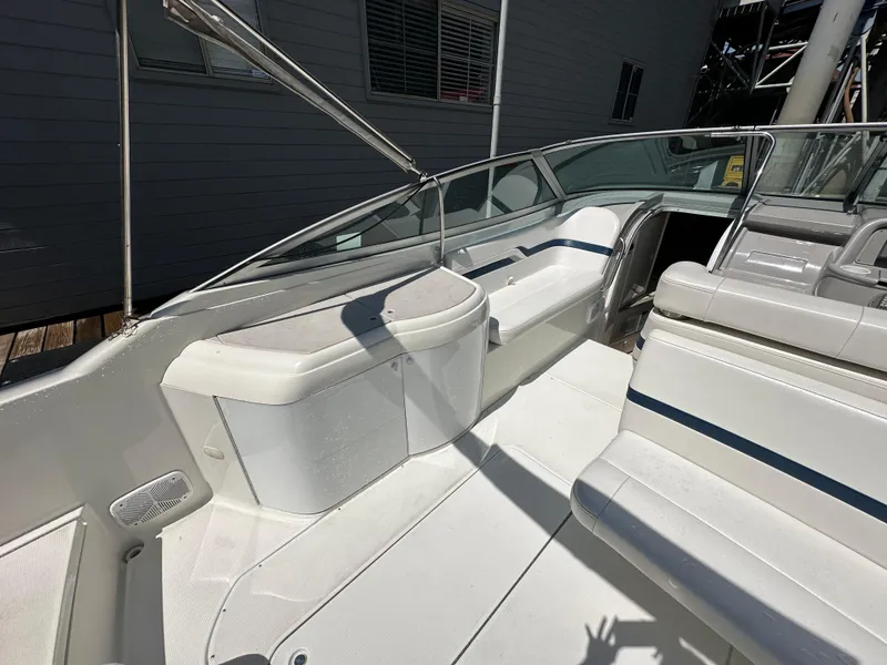 Slide: The Image of 2000 Formula 330 SS boat interior with white seating and sleek design. - 14