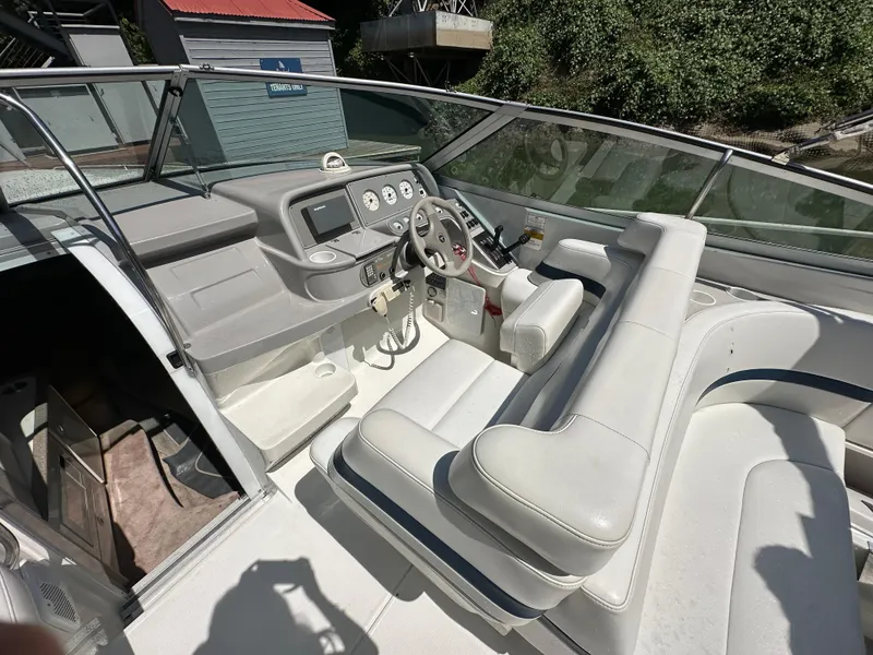 Slide: The Image of Interior of a 2000 Formula 330 SS boat with white seating and control panel. - 18
