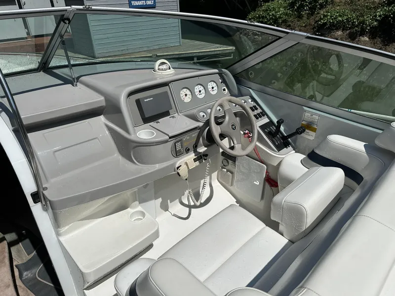 Slide: The Image of 2000 Formula 330 SS boat interior with steering wheel, gauges, and white seating. - 19