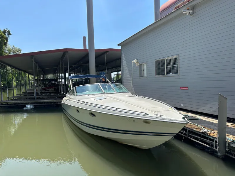 Slide: The Image of 2000 Formula 330 SS boat docked beside a marina building. - 2
