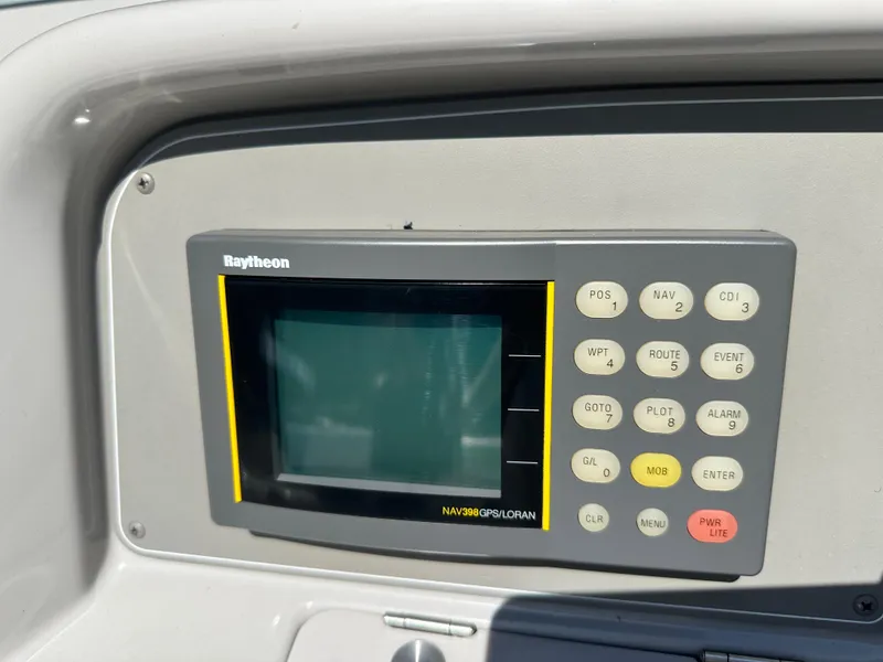 Slide: The Image of Raytheon navigation GPS unit on 2000 Formula 330 SS boat dashboard. - 22